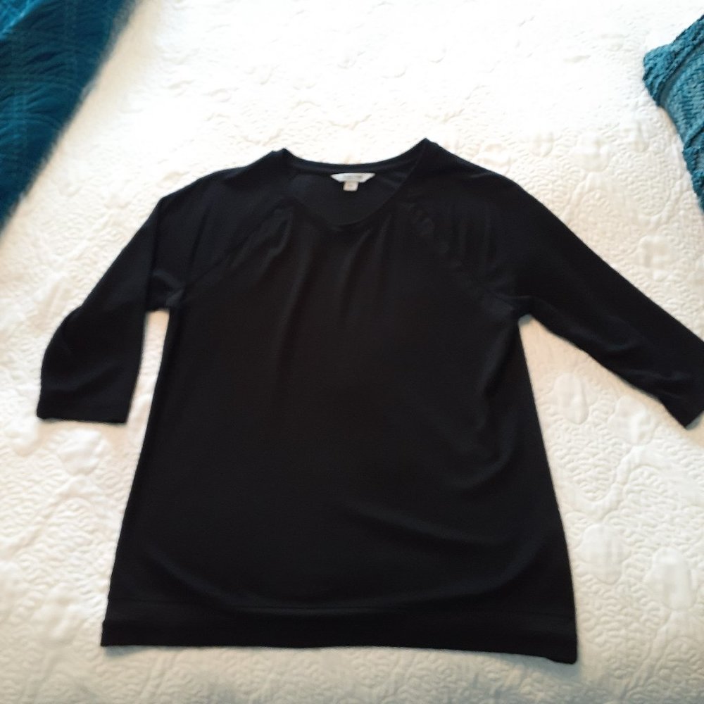 Black sweater with transparent inlay at the armpit and at the bottom.